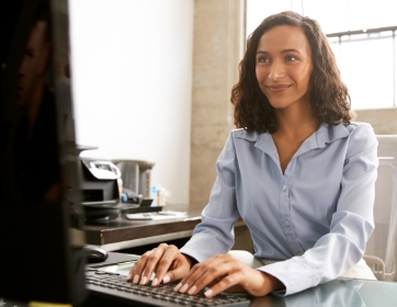 a worker typing at a computer